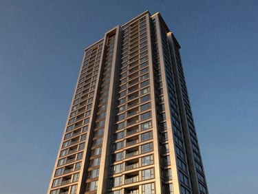 Architectural twilight photography of a luxury residential high-rise in Gurgaon, warm champagne lighting, modern steel and glass facade, sharp details