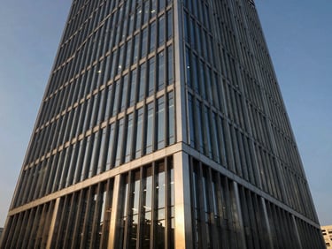 Abstract architectural angle of a modern steel-and-glass corporate headquarters in Gurgaon, sharp geometric lines, crisp afternoon sun casting dramatic shadows.