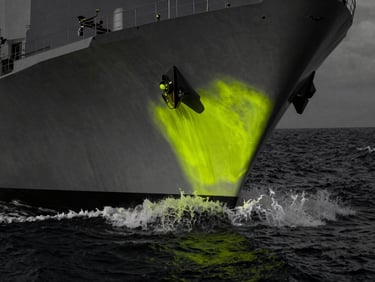 High-contrast industrial photography of a naval vessel hull cutting through dark ocean water, desaturated tones with sharp neon chartreuse highlights, dramatic low-key lighting