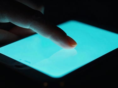 Extreme close-up macro shot of a finger interacting with a high-contrast dark-mode mobile screen, moody backlighting, sharp neon cyan screen glow
