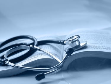 An open medical book with a stethoscope on top of it