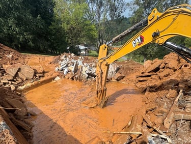 excavator digging out concrete pool