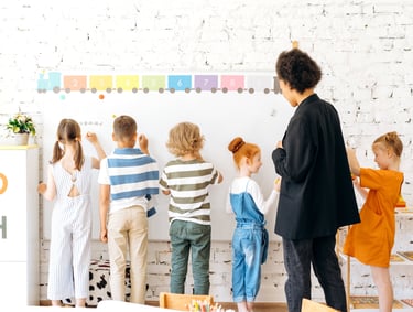 a teacher teaching children in a classroom