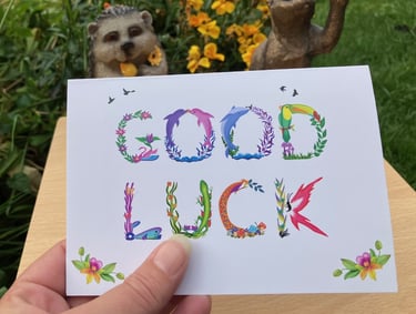 A greeting card with the words Good Luck printed in tropical exotic word art
