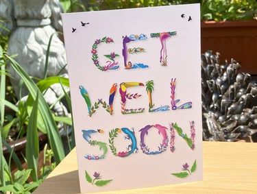 A greeting card with the words Get Well Soon printed in tropical exotic word art