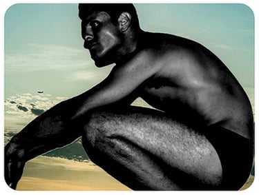 Photo of the artist Jason Elton Marks from the 90's in Speedos with vintage sky in background