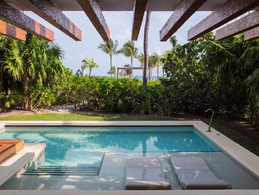 A view of the pool from the Honeymoon Suite at an Excellence Resort, palm trees