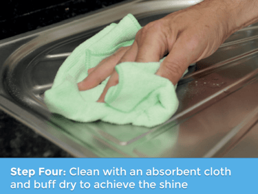 a person cleaning a sink with a cloth cloth