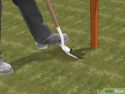 person digging up mailbox post