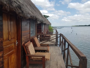 A serene view of the Bintang Bolong Lodge, featuring well-appointed cabins nestled within lush, trop
