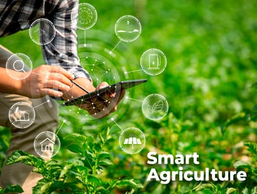 a man in a plaid shirt is holding a smart phone next to a farm