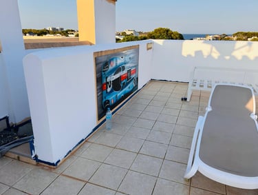 a patio with a lounge chair and a table