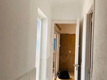 a hallway with a suitcase on the floor