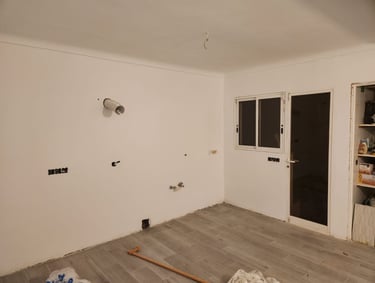 a room with a lot of white walls and a window