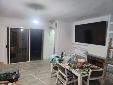 a living room with a television and a television