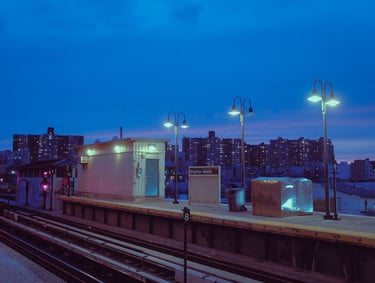A blue hour shot of a train station, lanterns softly lighting the scene.