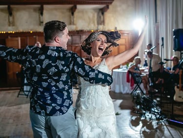 Bride dances with guest during South Wales wedding reception, captured in energetic candid style by photographer Owen Mathias