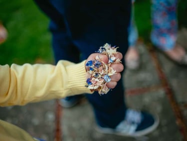a person holding confetti in a grip in their hand