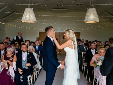 a bride and groom kissing in a wedding ceremony