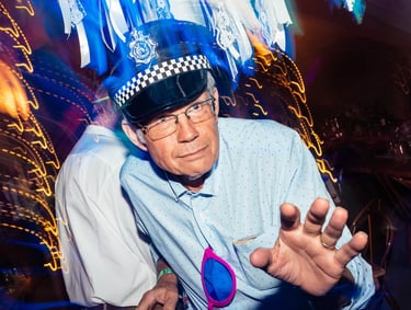 a man in a police hat dancing at a wedding