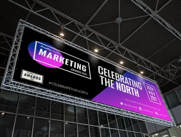 a billboard board with a large advertisement for Prolific North Marketing Awards