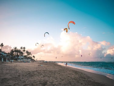 a beach with people flying kites and kites cabarete beach dominican republic