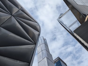 A view looking up into the sky from a place between several office buildings