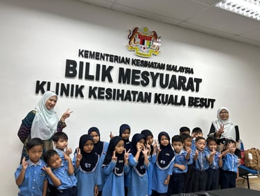 Students and teachers visiting the Kuala Besut Health Clinic meeting room in Malaysia.