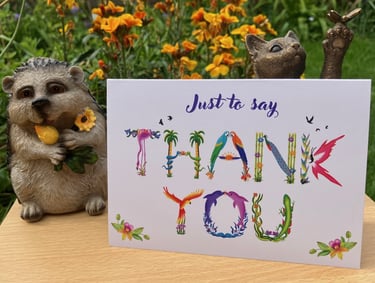 A greeting card with the words Just to say Thank You printed in tropical exotic word art