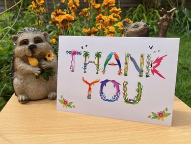 A greeting card with the words Thank You printed in tropical exotic word art