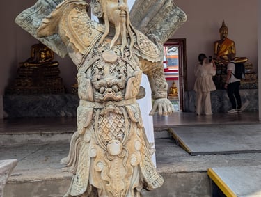 An ancient stone Chinese guardian statue at Wat Pho temple in Bangkok, Thailand.