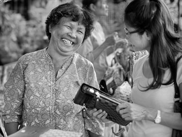 Thai street trader and customer haggling over price.