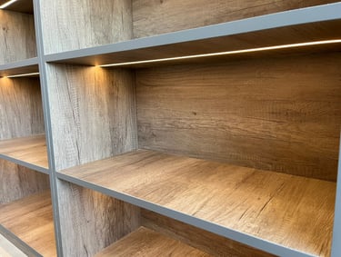 Modern rustic wood shelving unit with integrated LED strip lighting for home office storage.