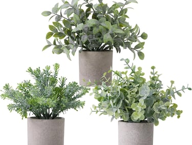 Set of three small artificial potted plants in grey concrete pots for home office decor.