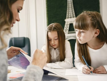 UKG home tutor teaching child at home with books and learning materials