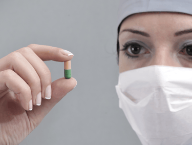 Scientist holding pill