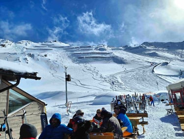 a group of people sitting at a table with skis