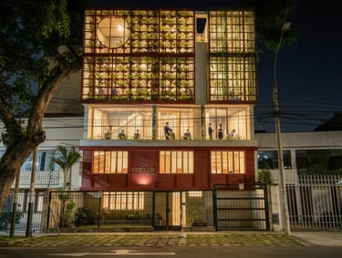 Modern office building at night featuring a vertical green wall and glass facade architecture.