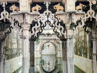 Ornate arches reflecting in the still waters of Rani Ji Ki Baori, Bundi — a mesmerizing play of stone and silence.