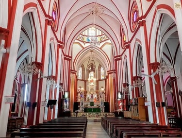Interior of the Sacred Heart Basilica in Pondicherry with stained-glass light.