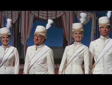 Circus set still from Jumbo (1962) with Doris Day, Jimmy Durante, and cast in white military‑style o