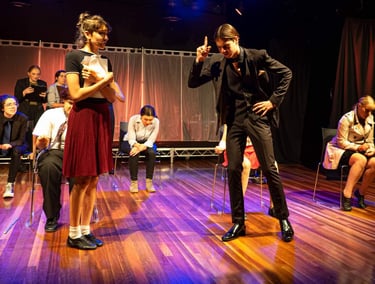 a man and woman in a stage setting