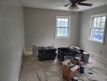 American Painting Specialist Fort Wayne, Indiana repainting a bedroom with gray walls and white trim