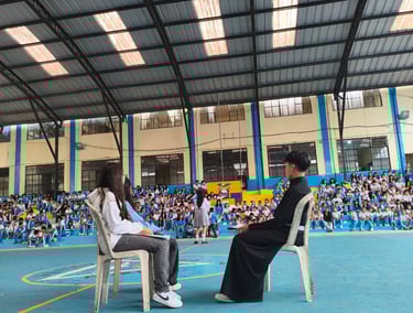 a man and woman sitting on chairs in a gym