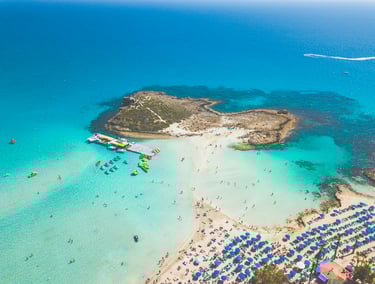 Cyprus beaches with clear water and sandy bays, popular spots like Coral Bay and Fig Tree Bay