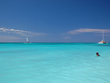 Sunny Caribbean coastline with clear blue skies and turquoise sea