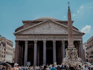 Exterior of the Pantheon in Rome with large columns and a domed roof