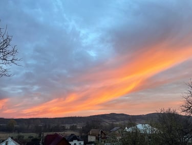 a sunset sky with a pink sky and a few clouds