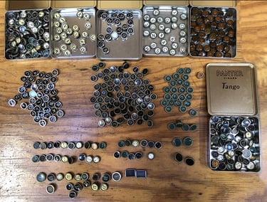 A large collection of many typewriter keys from different typewriters.