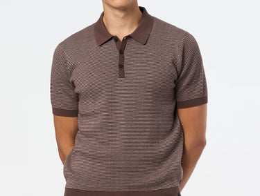 a man in a striped brown shirt and jeans